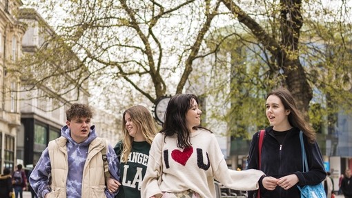 Four students walking in Cardiff City Centre